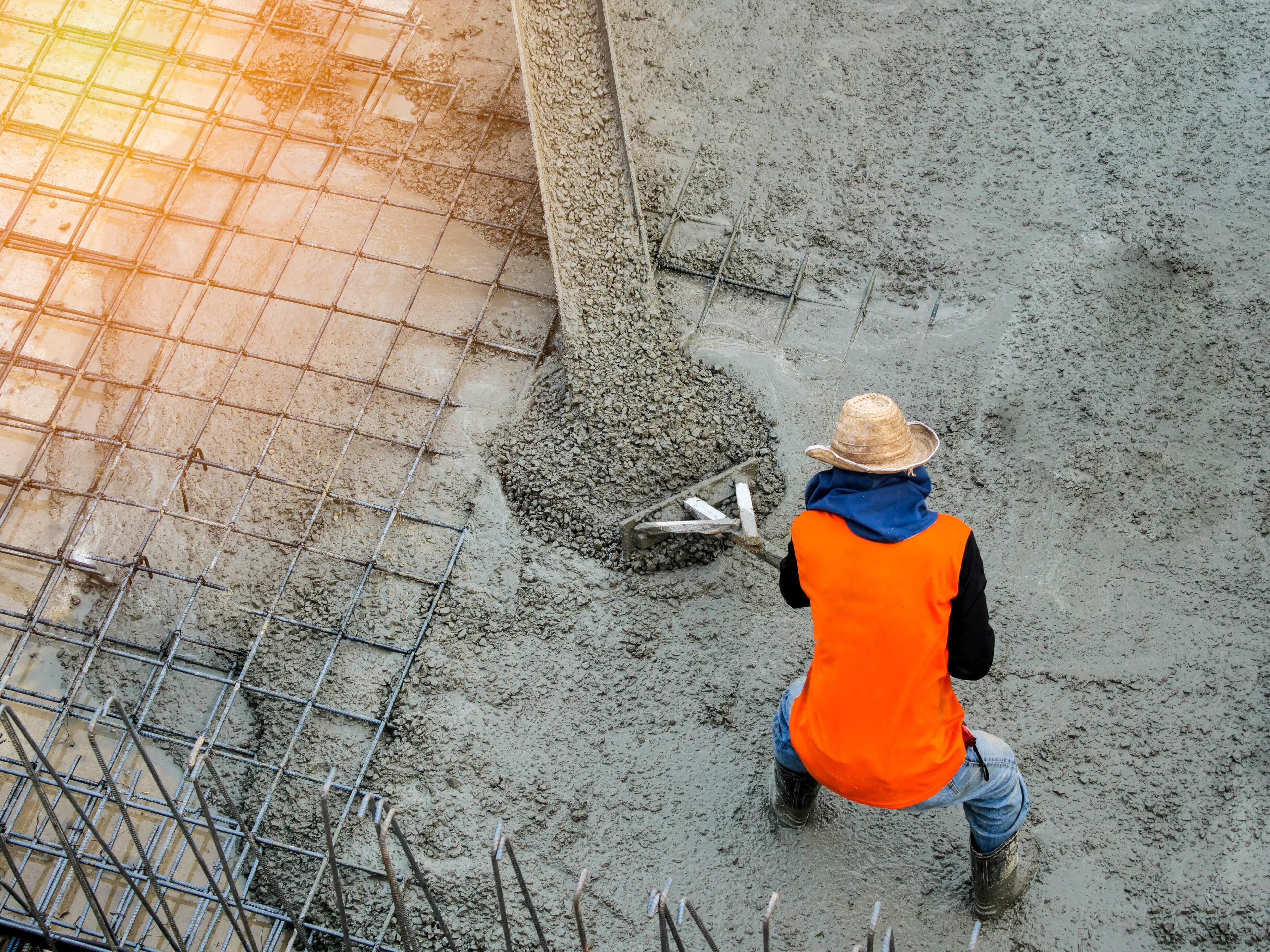 Pouring ready-mixed concrete after placing steel reinforcement to make the road by mixing mobile the concrete mixer.