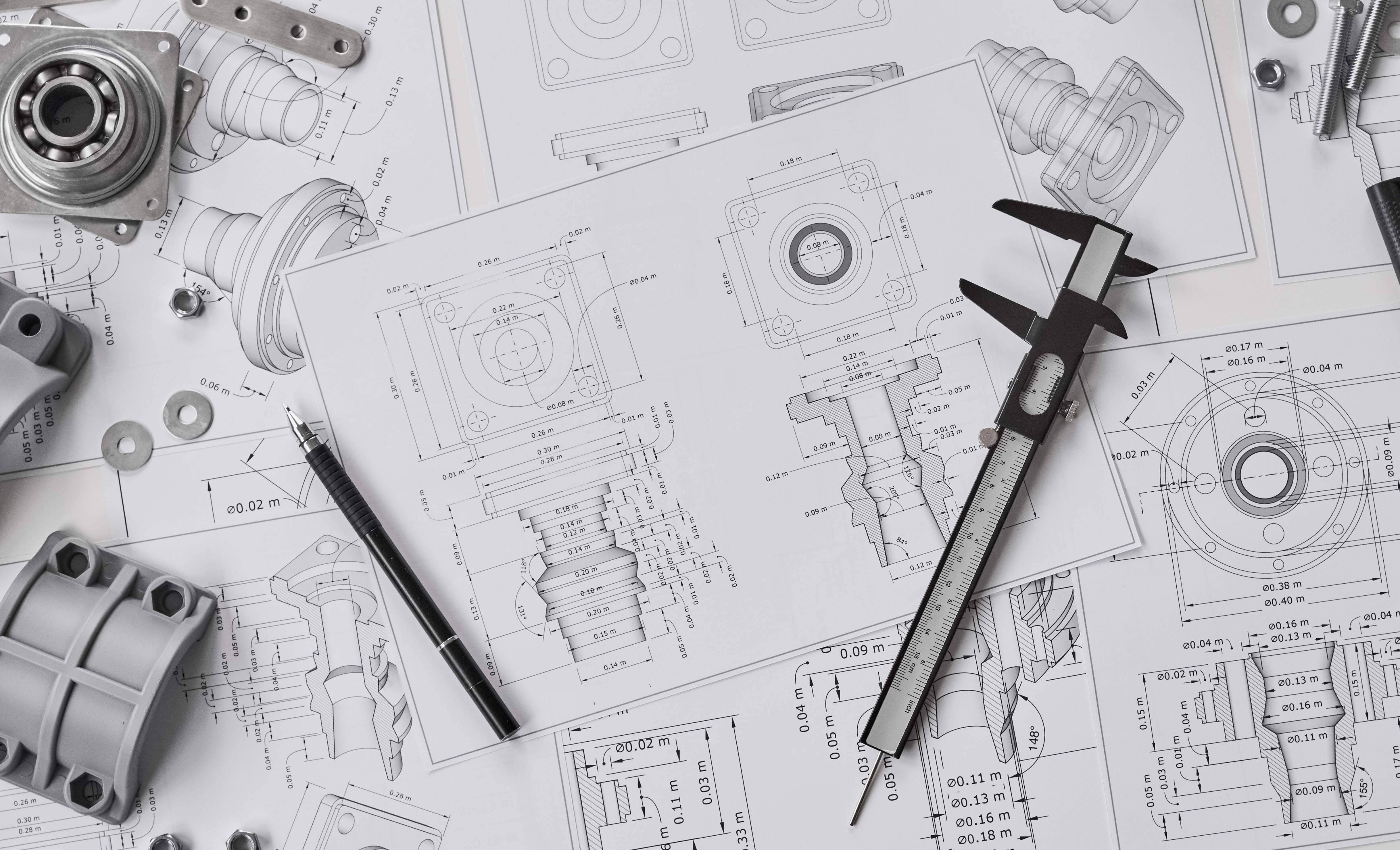 Engineer technician designing drawings mechanical parts engineering Engine manufacturing factory Industry Industrial work project blueprints measuring bearings caliper tool.