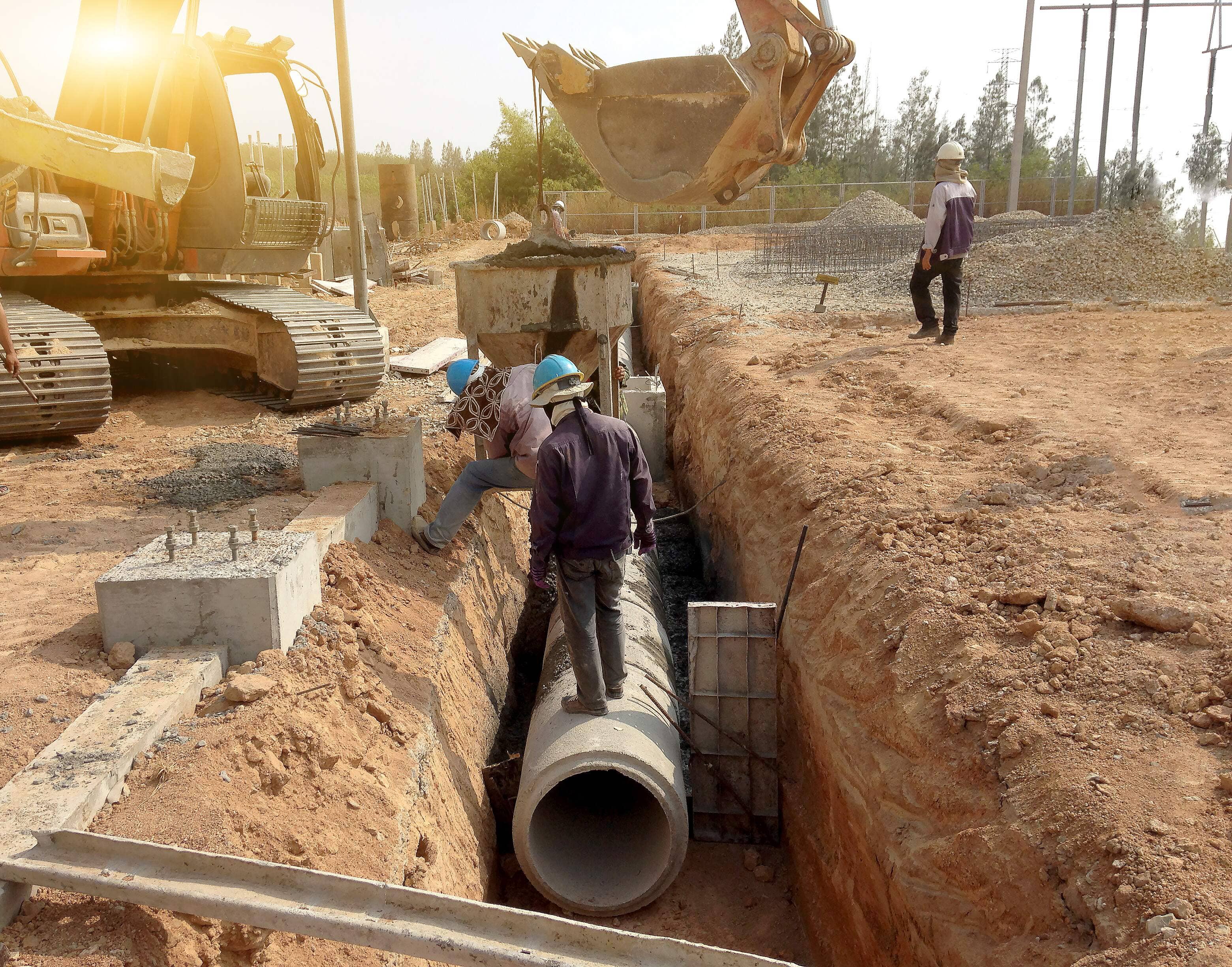 Laying underground storm sewers at a construction site. Groundwater system for new residential buildings in the city